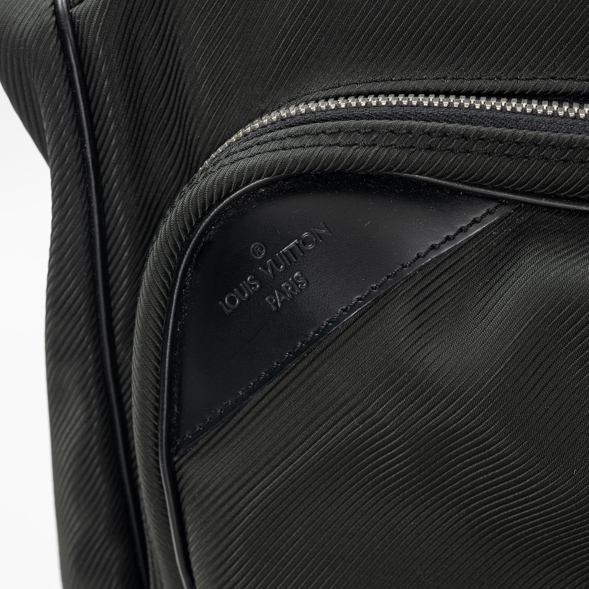 Louis Vuitton, a green canvas and Taiga garment bag.