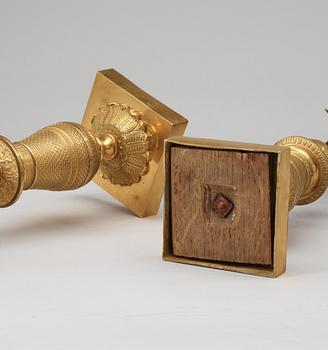A pair of French Empire early 19th century three-light candelabra.