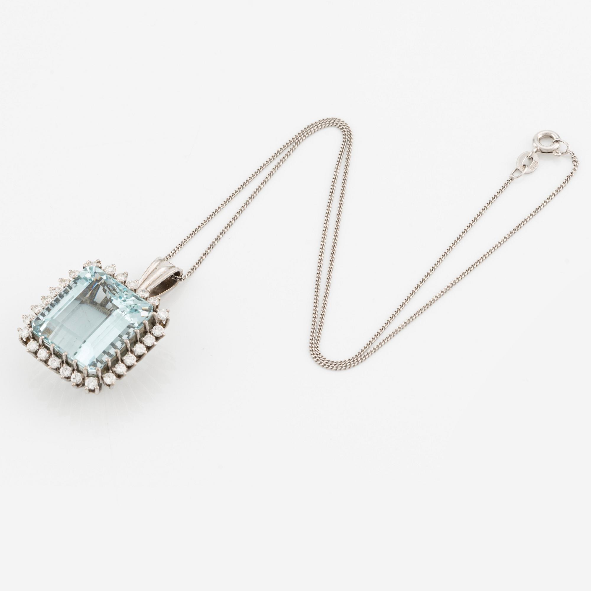 An 18K white gold Engelbert pendant set with a aquamarine and round brilliant-cut diamonds.