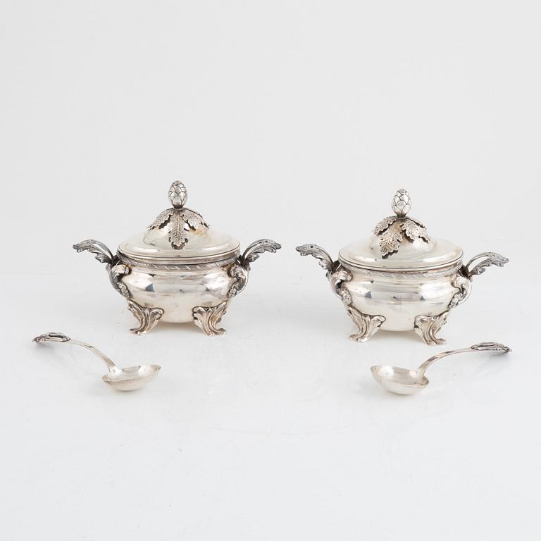 A pair of Swedish Rococo style sterling silver sauce tureens with lid and spoons, mark of Wiwen Nilsson, Lund 1947-1948.