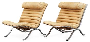 A pair of Arne Norell "Ari" brown leather and steel easy chairs by Norell.