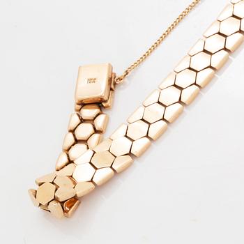 An 18K gold bracelet.