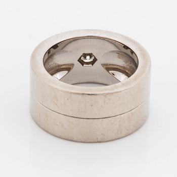 A Cartier 18K white gold ring set with a round brilliant-cut diamond.