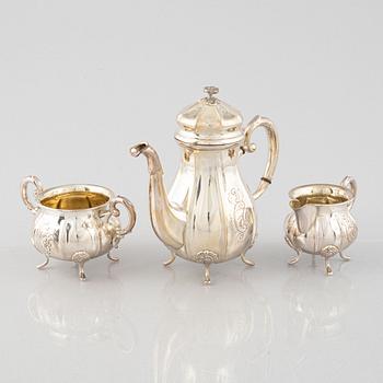 A Swedish Rococo Style Coffee Pot, Creamer and Sugar Bowl, mark of JE Skreij, Falun 1951-55.