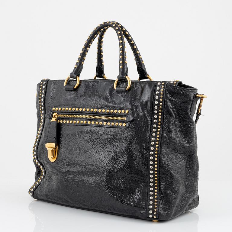 Prada, A black leather and gold stud bag.