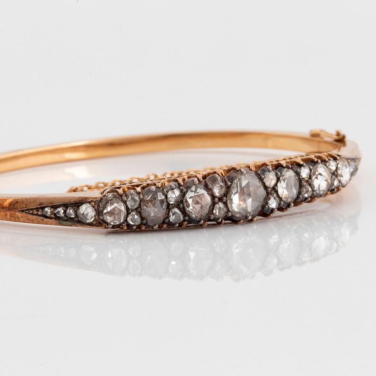 An 18K gold and silver bangle set with rose-cut diamonds.