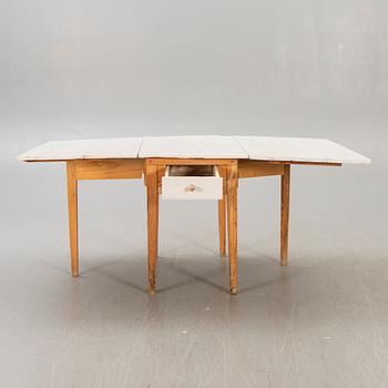 A painted gate legged table later part of the 19th century.