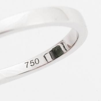 An 18K white gold ring set with a step-cut green tourmaline and round brilliant-cut diamonds.