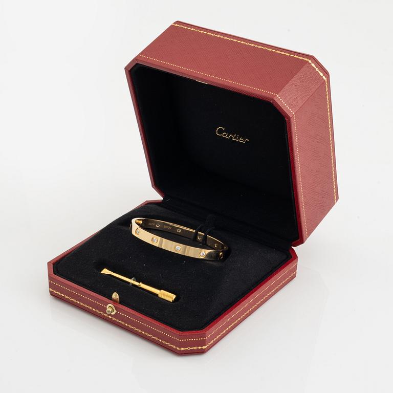 A Cartier "Love" bracelet in 18K gold set with ten round brilliant-cut diamonds.