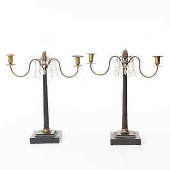 A pair of wooden candelabras, around 1900.