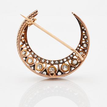 A crescent moon brooch.