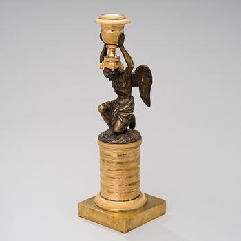 A ORMOLU CANDLESTICK, bronze and gilded bronze, empire early 19th century.