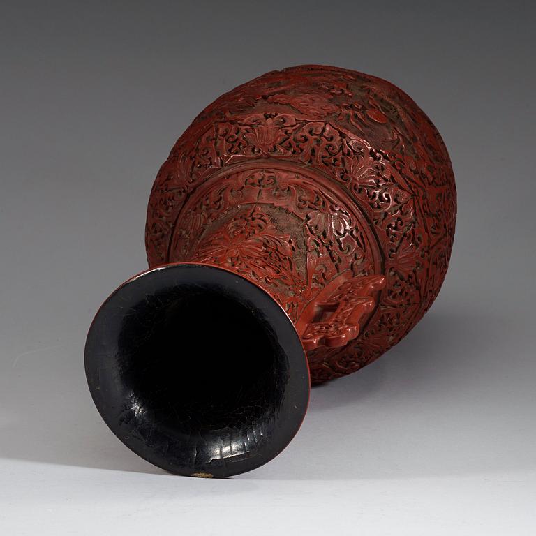 A lacquer vase, late Qing Dynasty (1644-1912) with Qianlong mark.