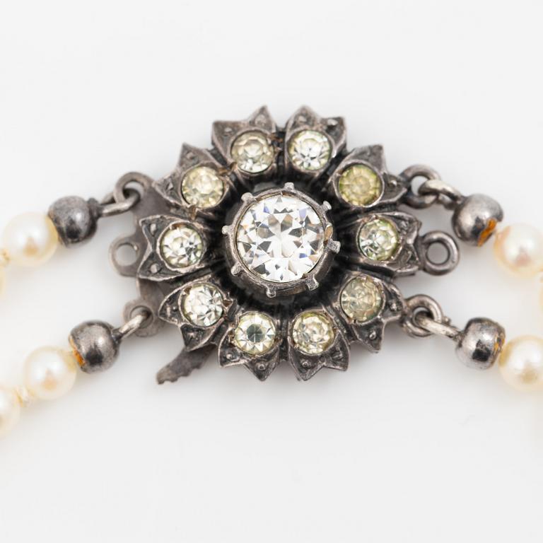 Double-row necklace with graduated cultured pearls, silver clasp set with paste stones.
