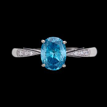 210. RING, treated blue diamond, app 1 ct, with small diamonds.