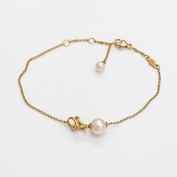 Georg Jensen, An 18K gold bracelet "Magic" with a cultured pearl and diamonds ca. 0.048 ct in total, Denmark.