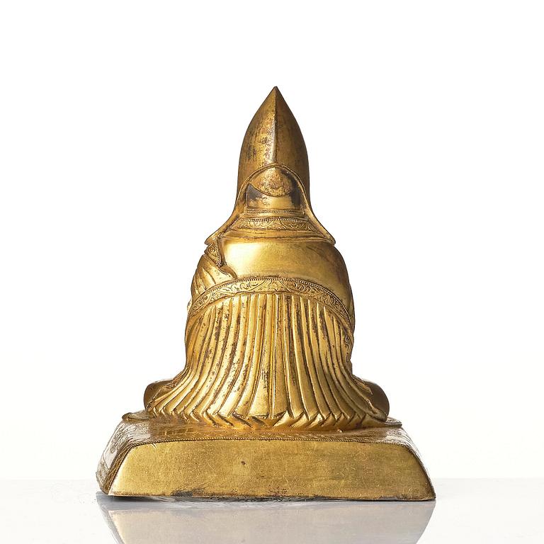 A gilt bronze figure of a Lama, Tibeto-Chinese, 18th/19th century.