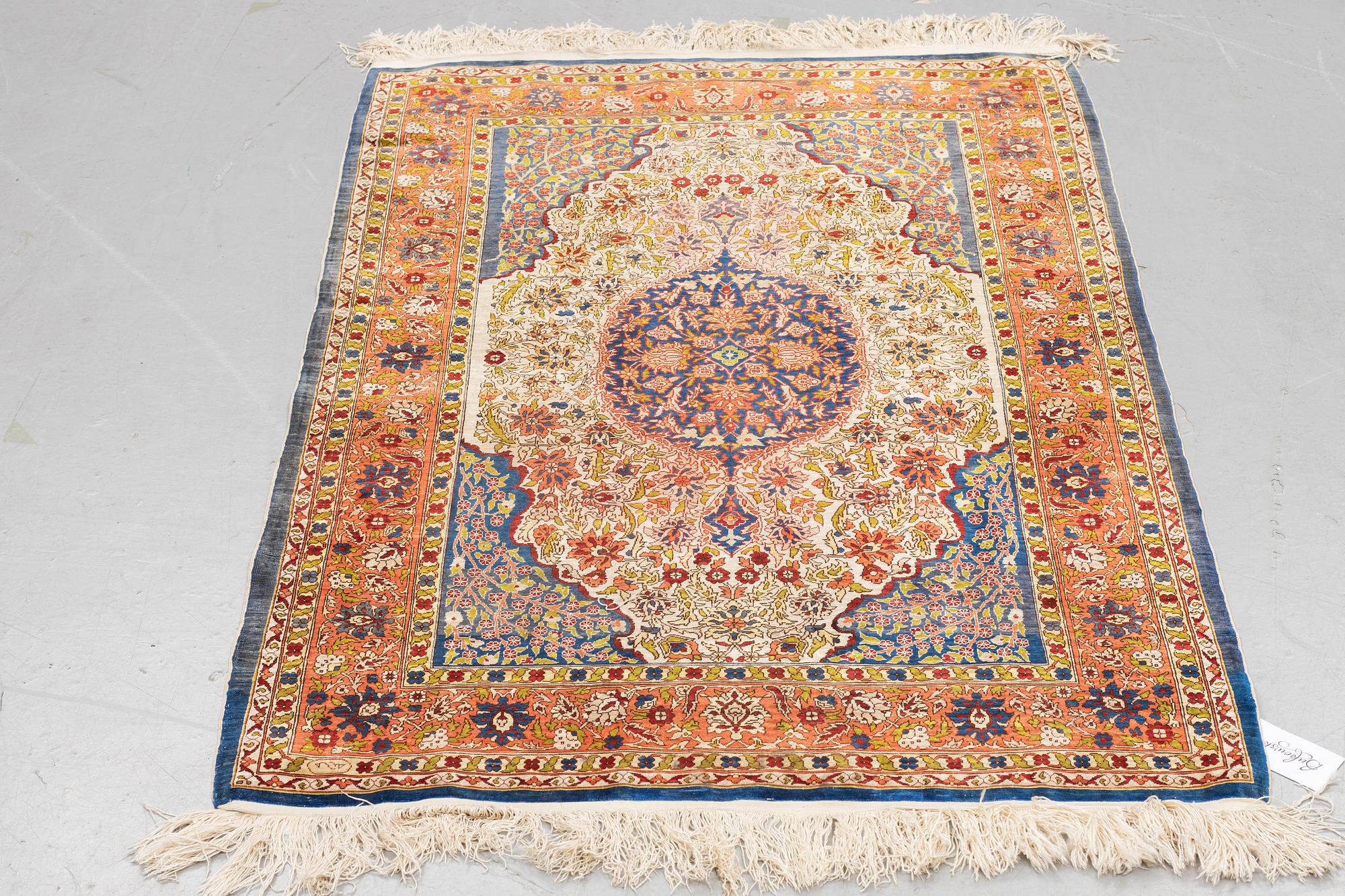 A rug, Old silk Hereke, ca 136 x 92 cm.