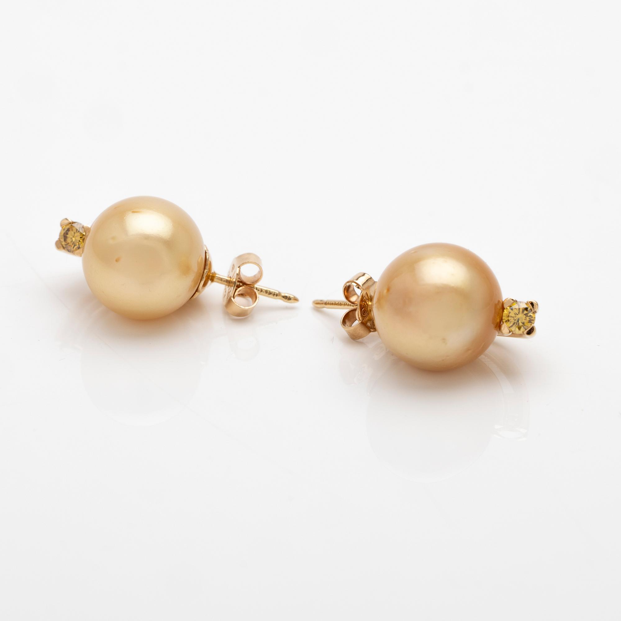 18K gold earrings with South Sea pearls and diamonds.