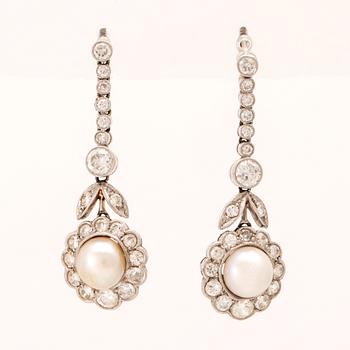 A pair of 18K white gold earrings set with cultured pearls and round brilliant-cut and old-cut diamonds.