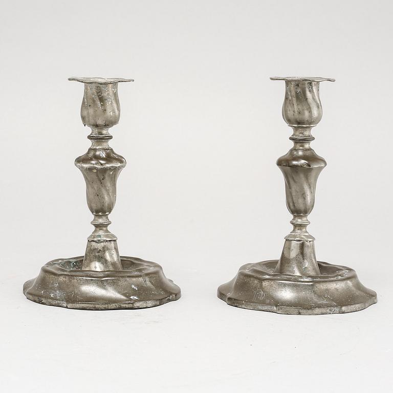 A pair of Rococo candlesticks in pewter, made by Eric Pettersson Krietz in Stockholm 1763.