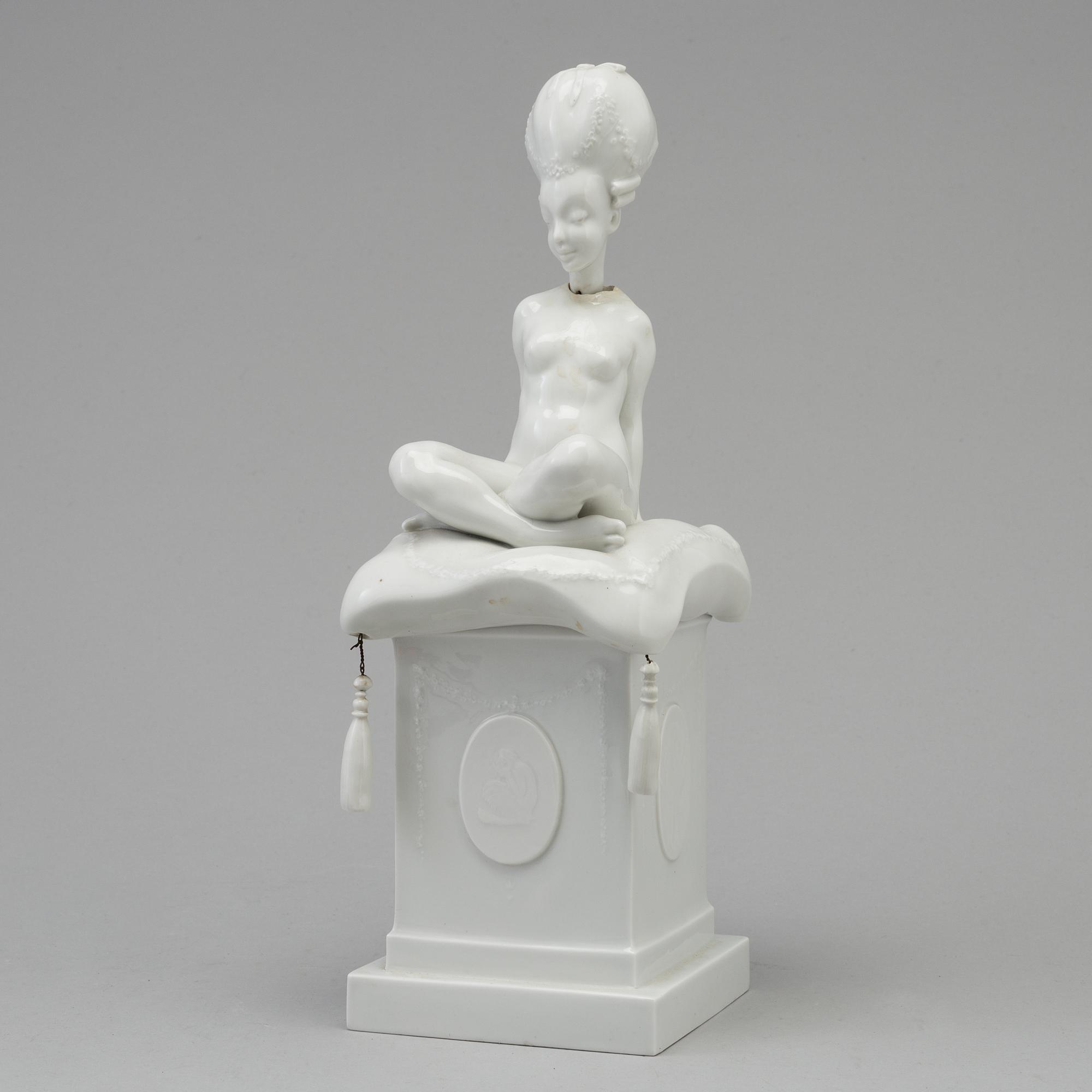 A white glazed Royal Copenhagen porcelain nodding head figure, Denmark, early 20th Century. Not first quality.