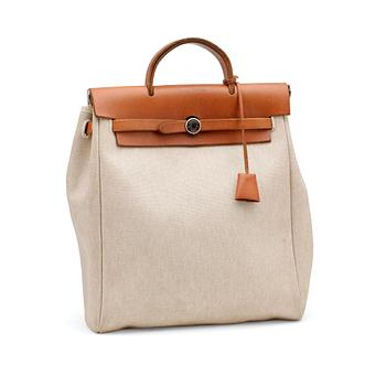 444. HERMÈS, a canvas and leather bag in two parts, "Herbag".