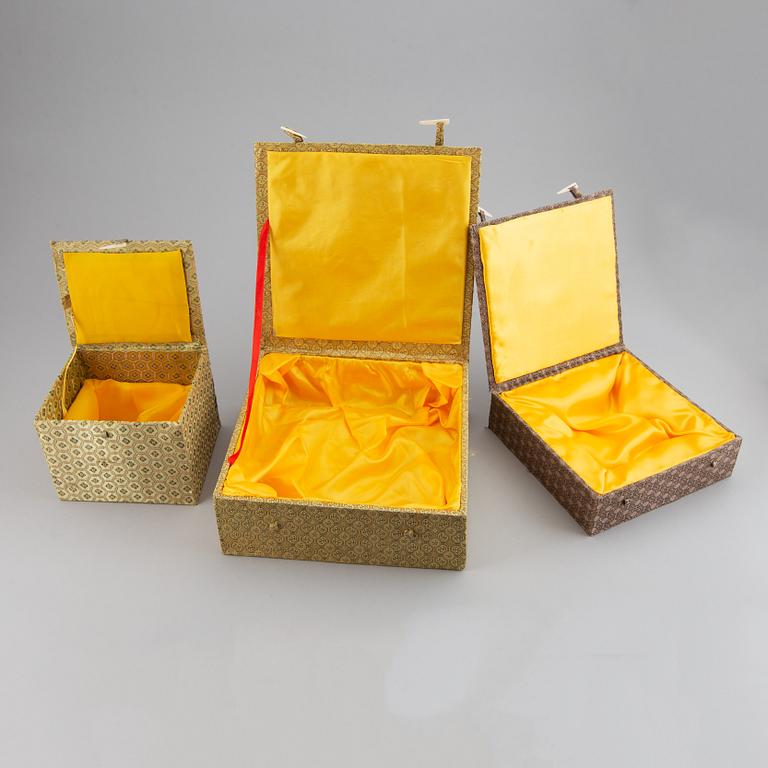 A set of six silk clad boxes, China, 20th Century.