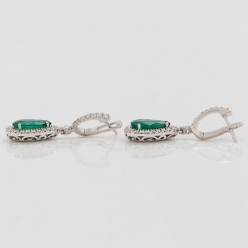 A pair of earrings with emeralds, total carat weight 4.35 cts, and diamonds, total carat weight 1.11 ct.