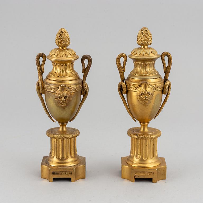 A pair of bronze empire style casolettes from around the year 1900.