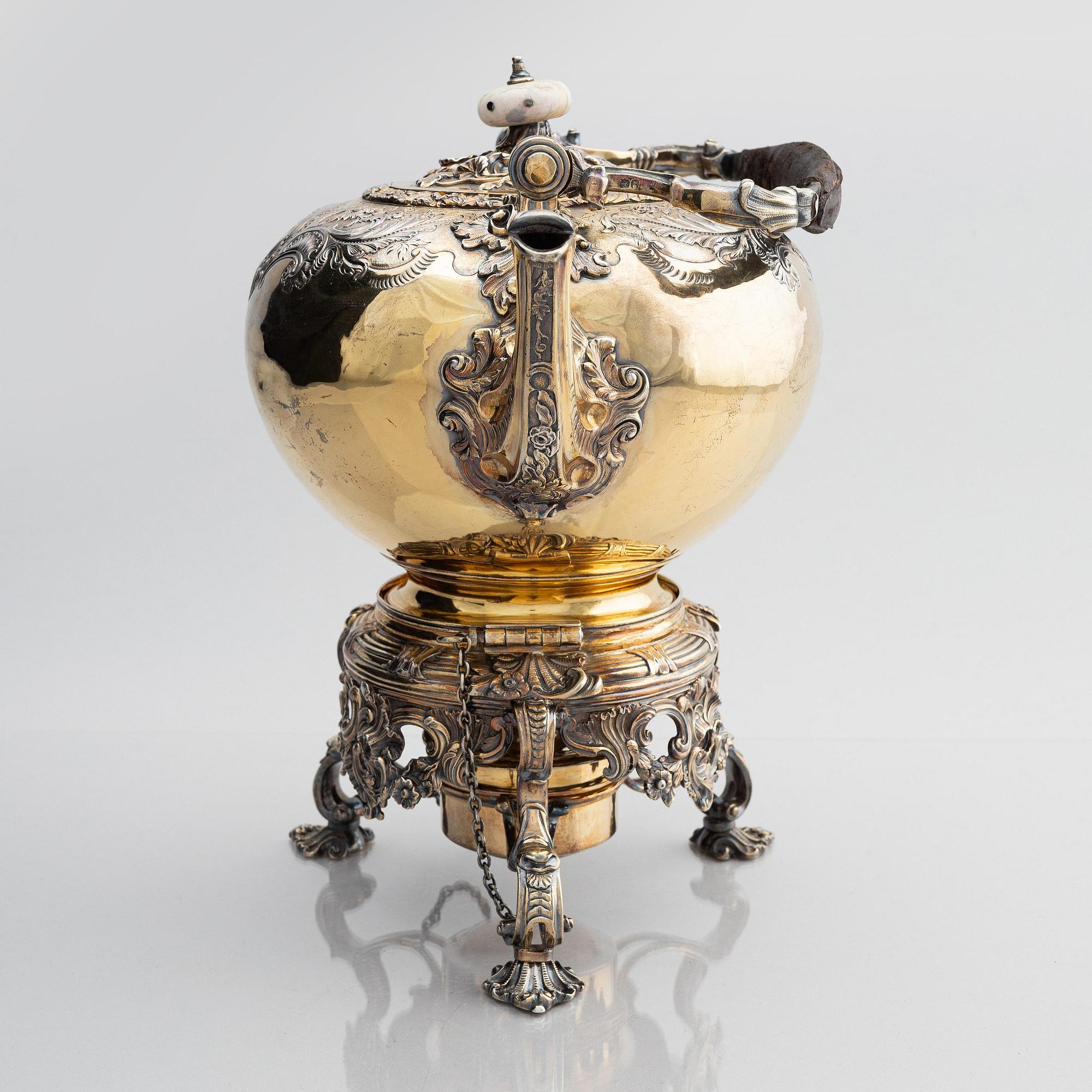 An English silver-gilt teapot with stand and burner, mark of Richard Sibley I, London 1825.