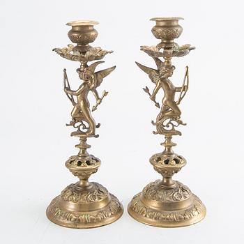 A pair of late 19th century brass candlesticks.