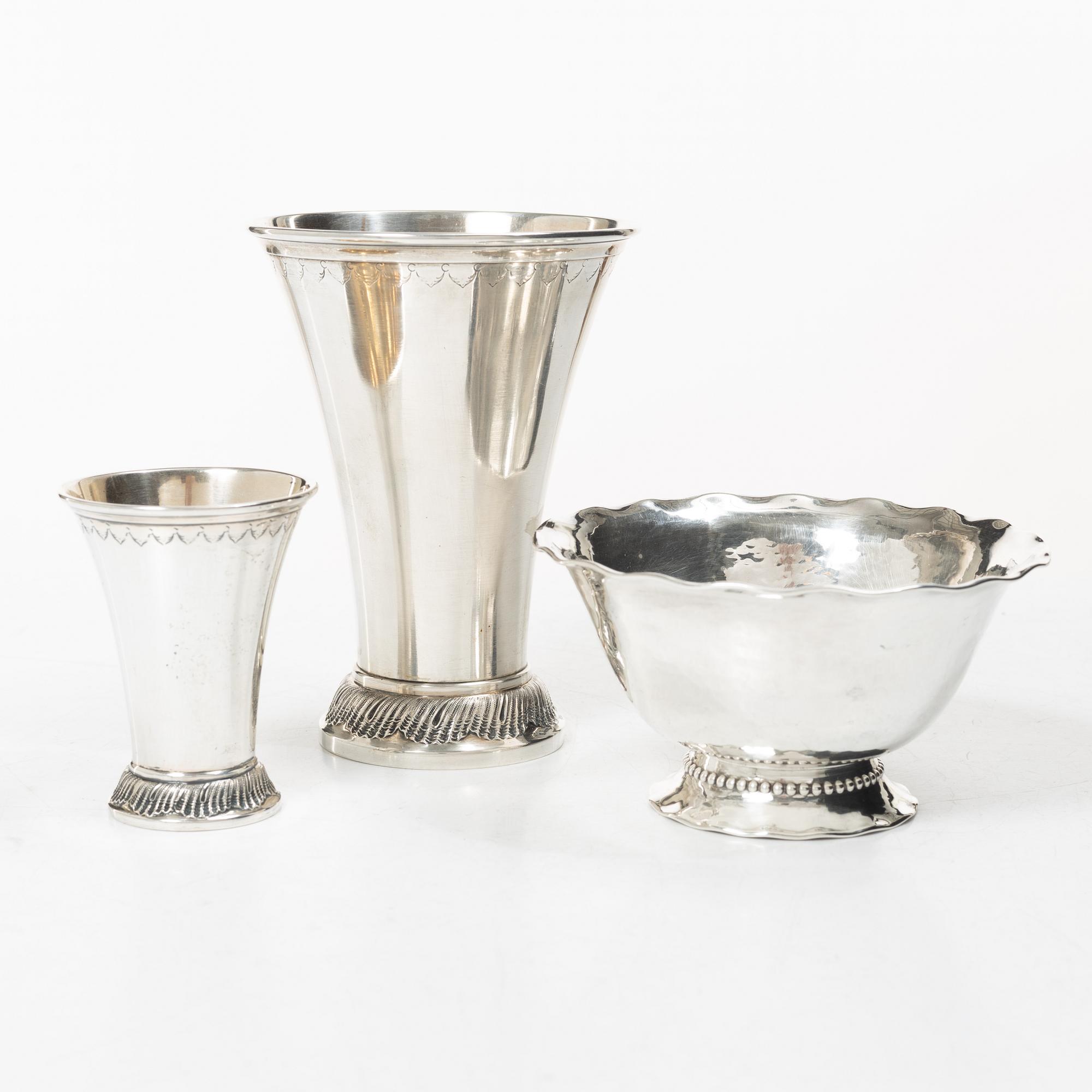 Two silver beakers and a bowl,
