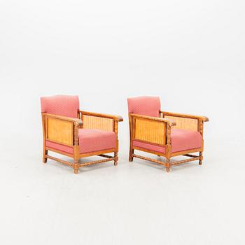 A pair of lacquered wood and rattan easy chairs from the middle of the 20th century.