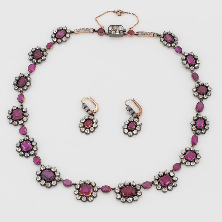 A Demi parure comprising a necklace and a pair of earrings set with rubies and old-cut diamonds.