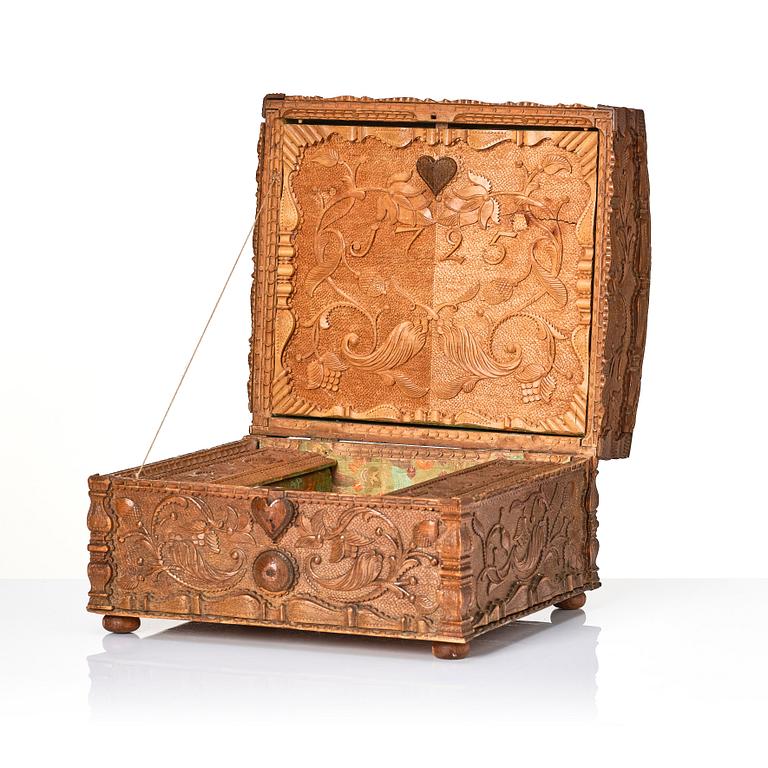 A baroque wedding casket, carved wood, dated 1725.