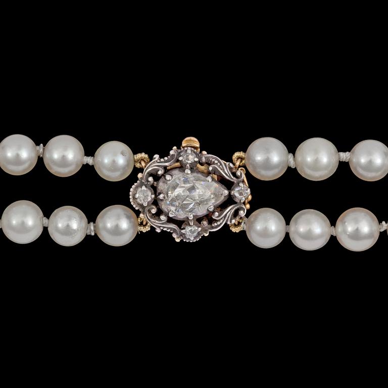 A two strand cultured pearl necklace, 7,4 mm, rose cut diamond clasp.