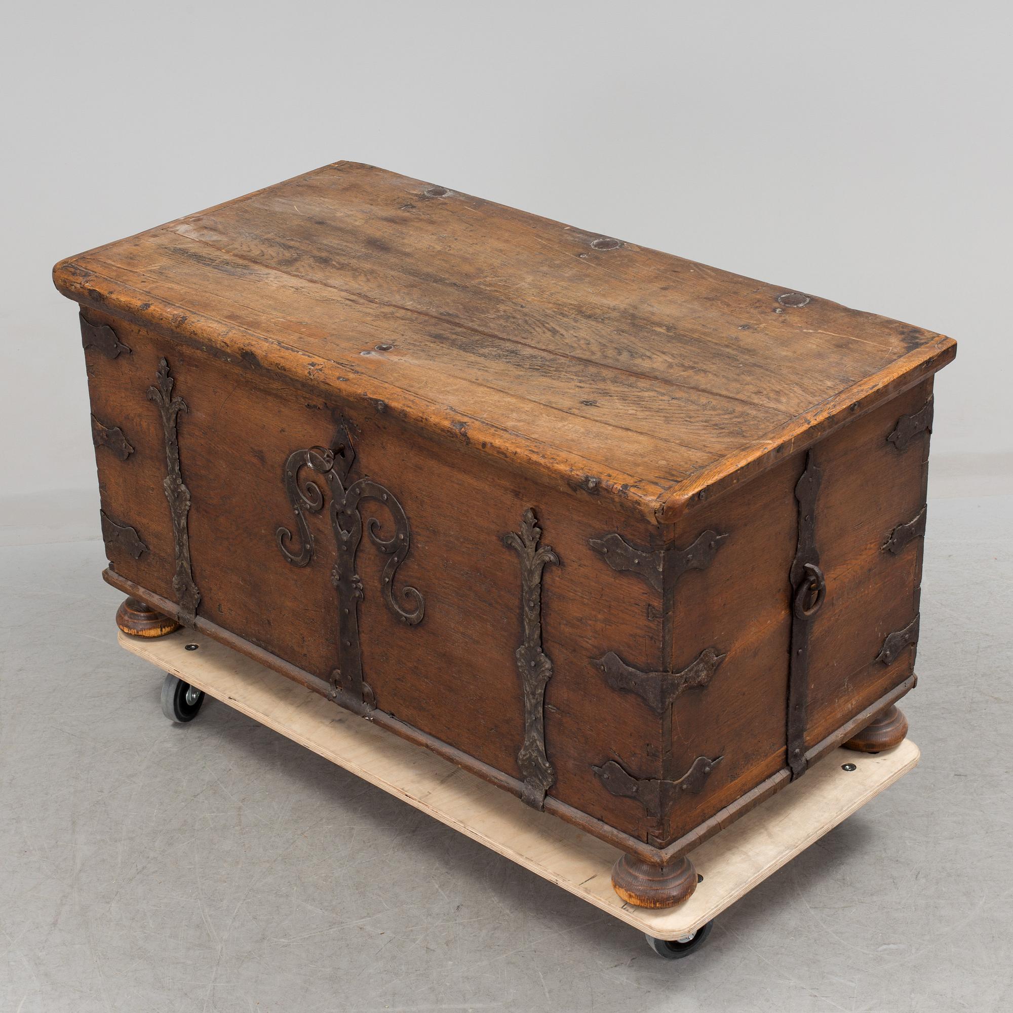 A large 17/17th century baroque oak chest with wrought iron fittings.