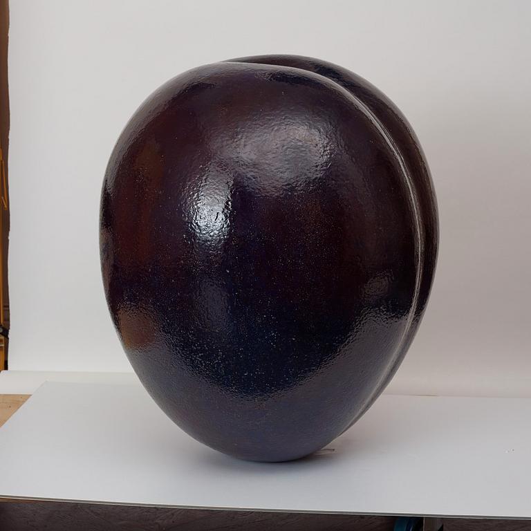 A Hans Hedberg faience sculpture of a plum, Biot, France.