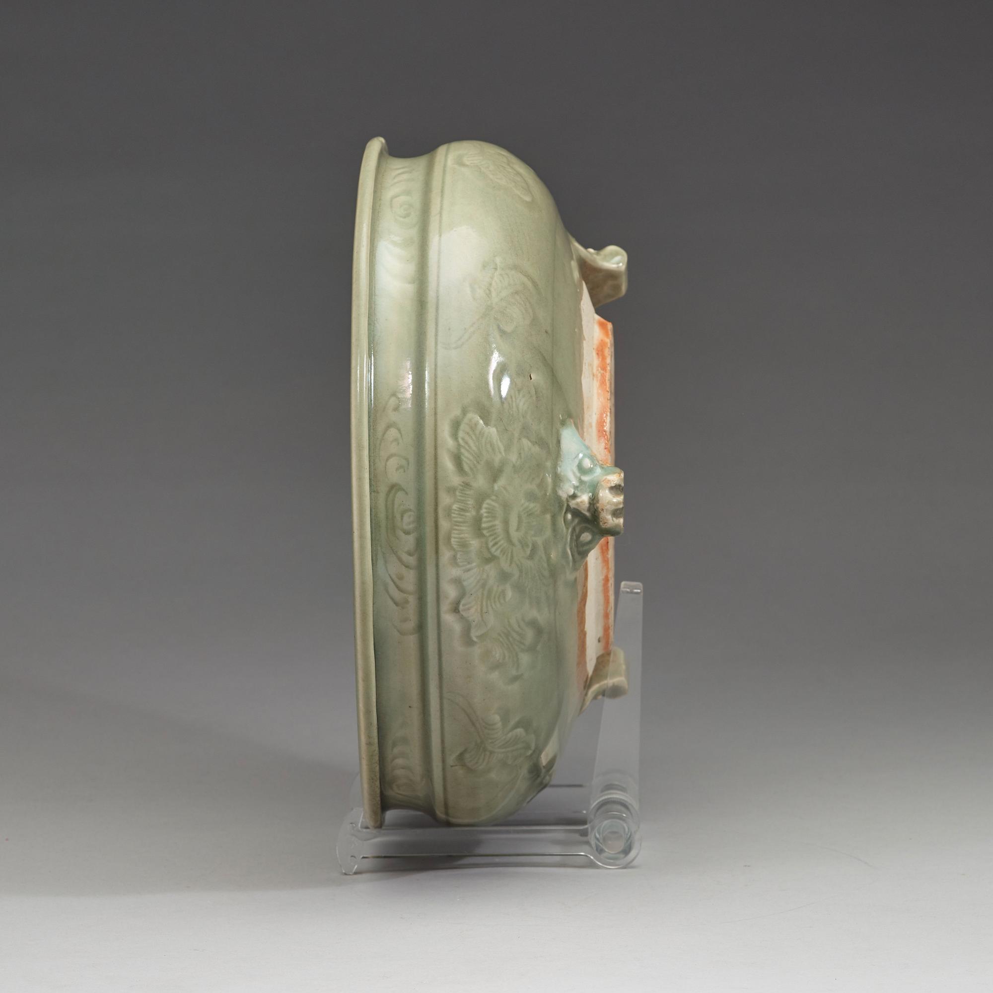 A large tripod celadon censer, presumably late Ming dynasty (1368-1644).