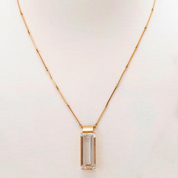 An 18K gold necklace set with a step cut rock crystal quartz by Ateljé Stigbert 1943.