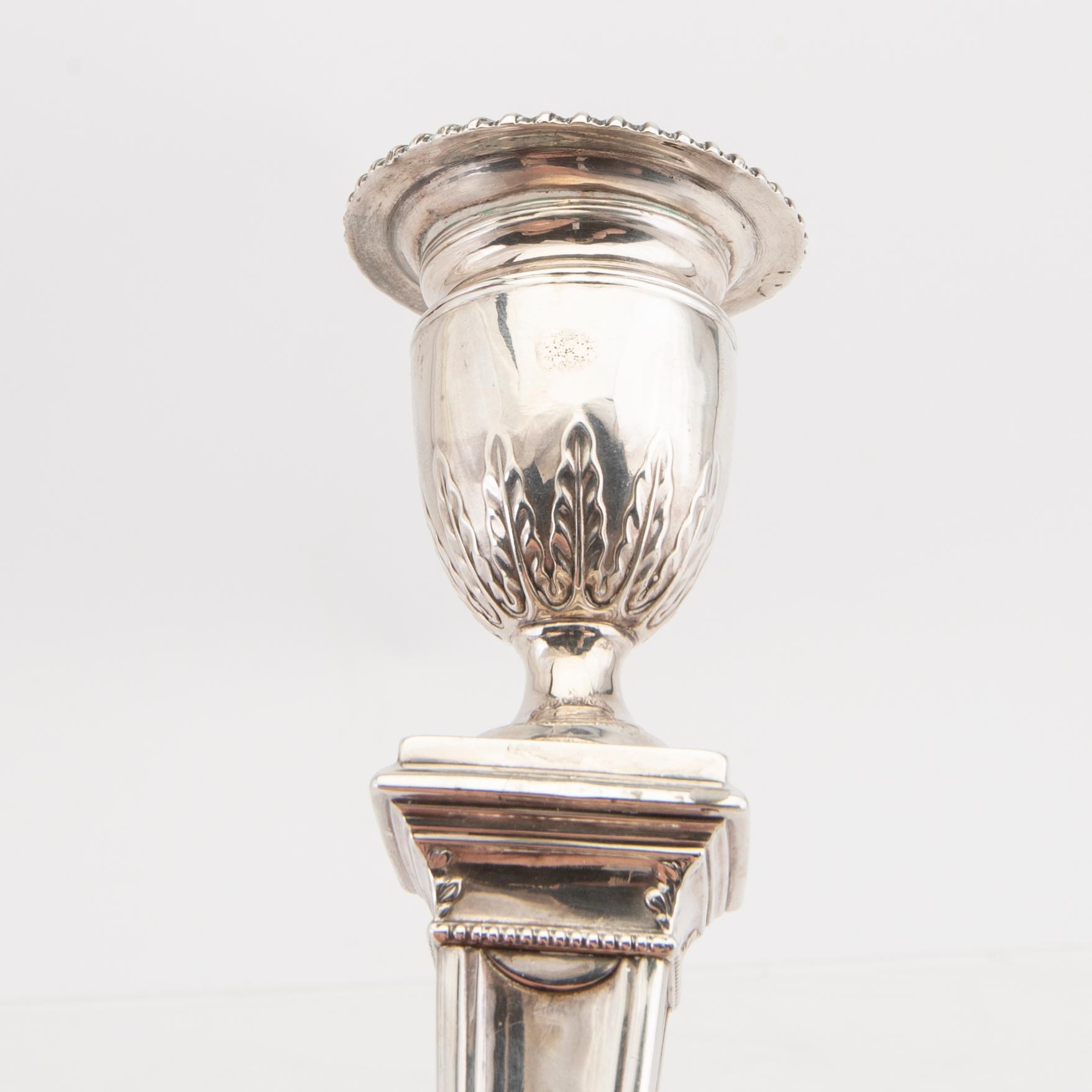 An English 20th century pair of silver candle sticks mark of Mappin & Webb London around 1900.