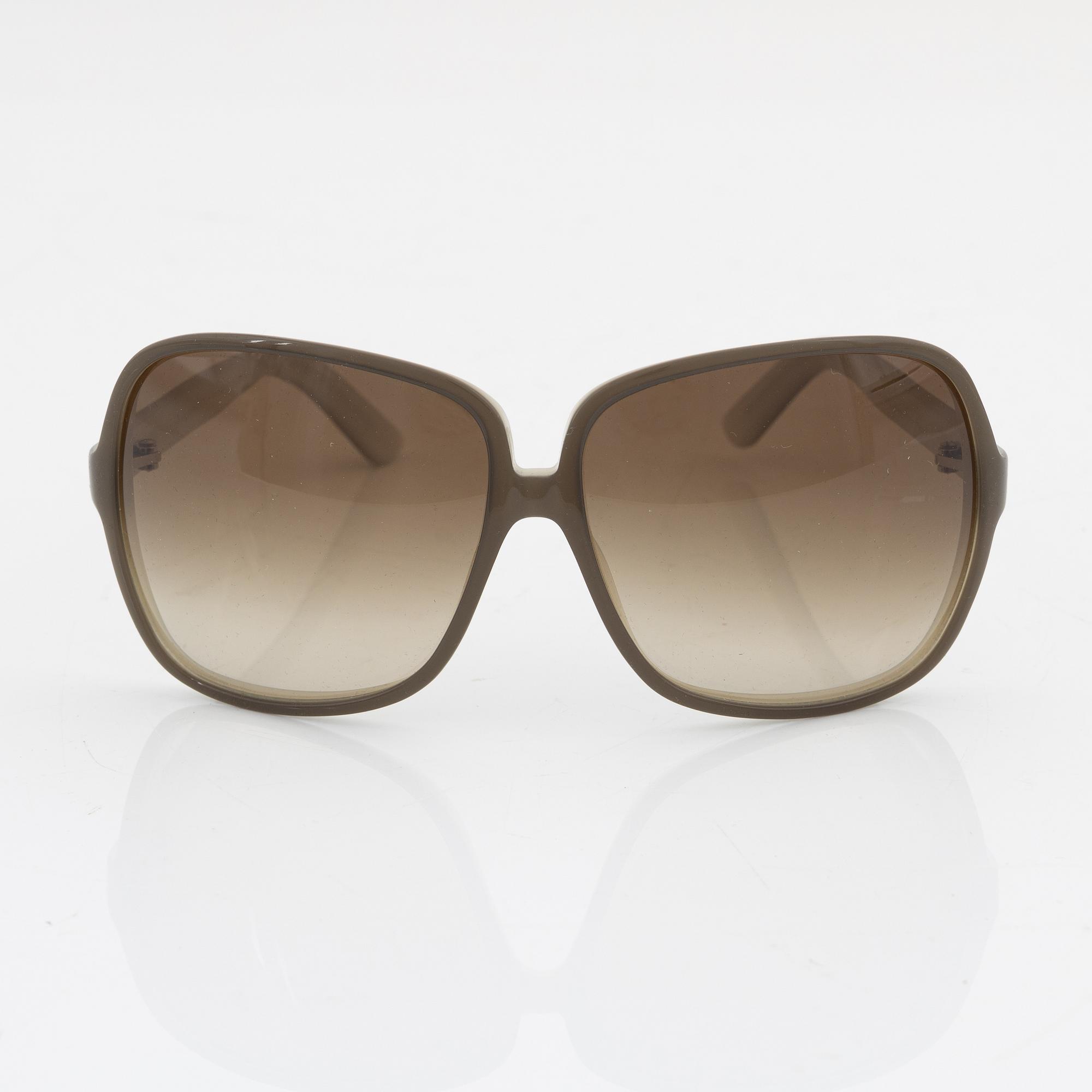 Yves Saint Laurent, a pair of grey plastic sunglasses.