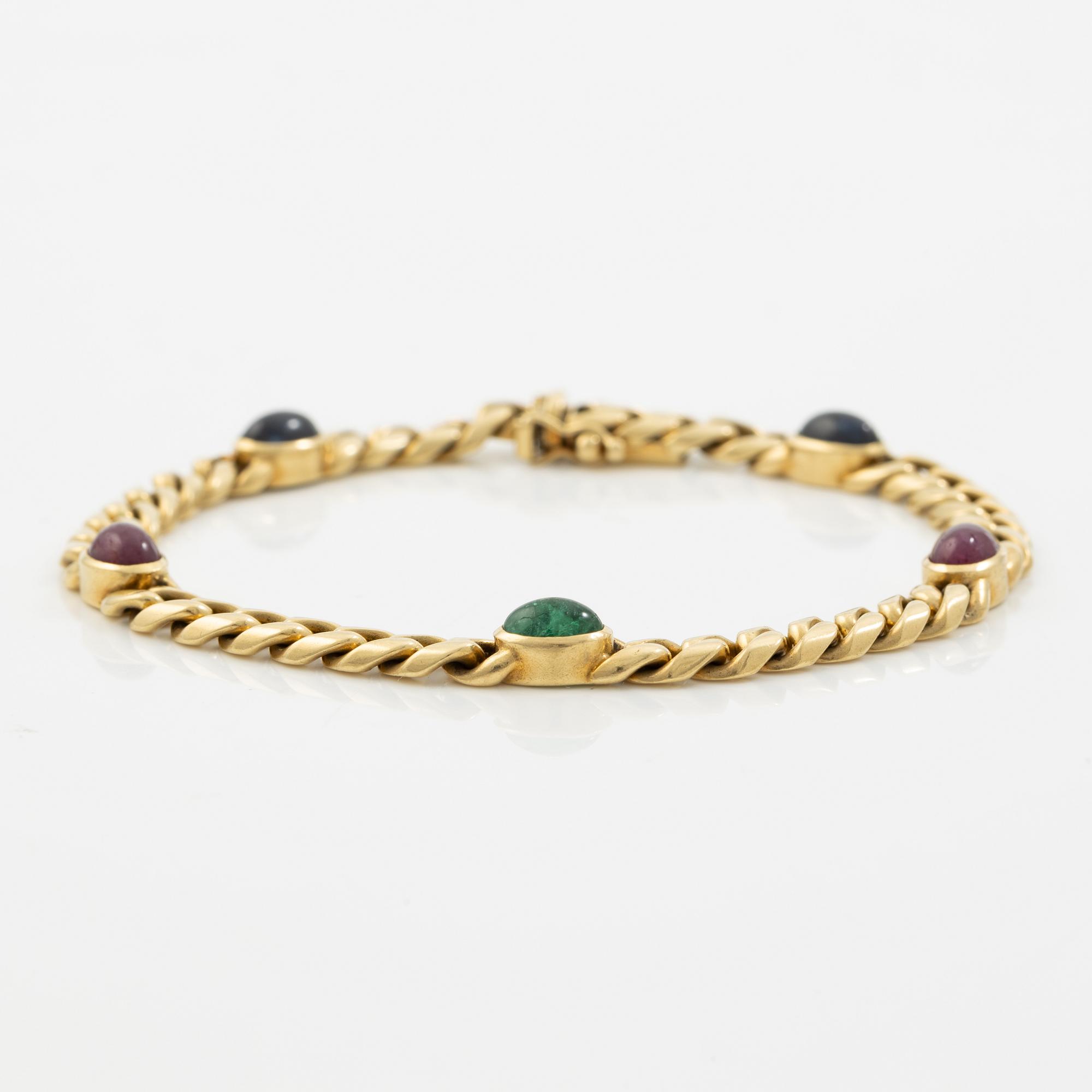 Bracelet in 18K gold set with cabochon-cut emeralds, rubies, and sapphires.