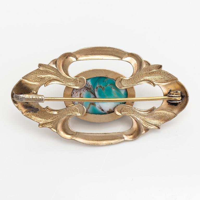 Elis Kauppi, A gilded silver brooch with a glass stone. Kupittaan kulta, Turku, 1940's.