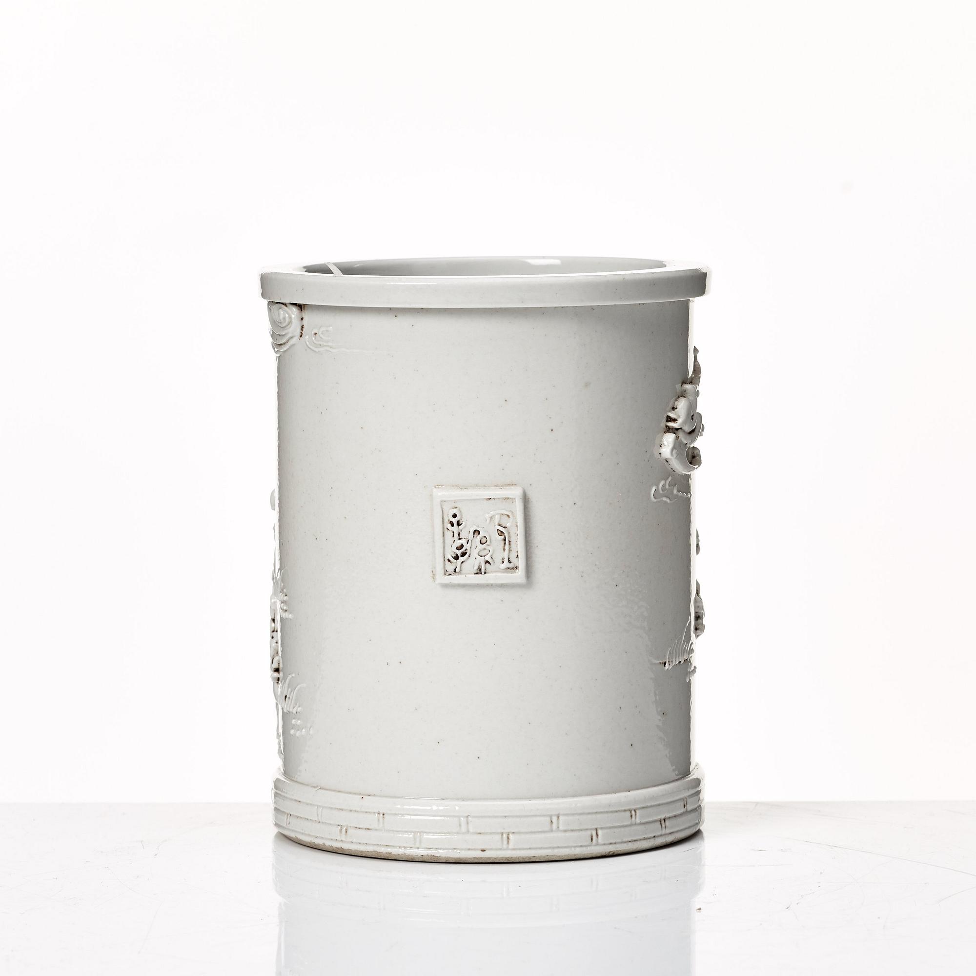 A white glazed Chinese brush pot, presumably late Qing dynasty.