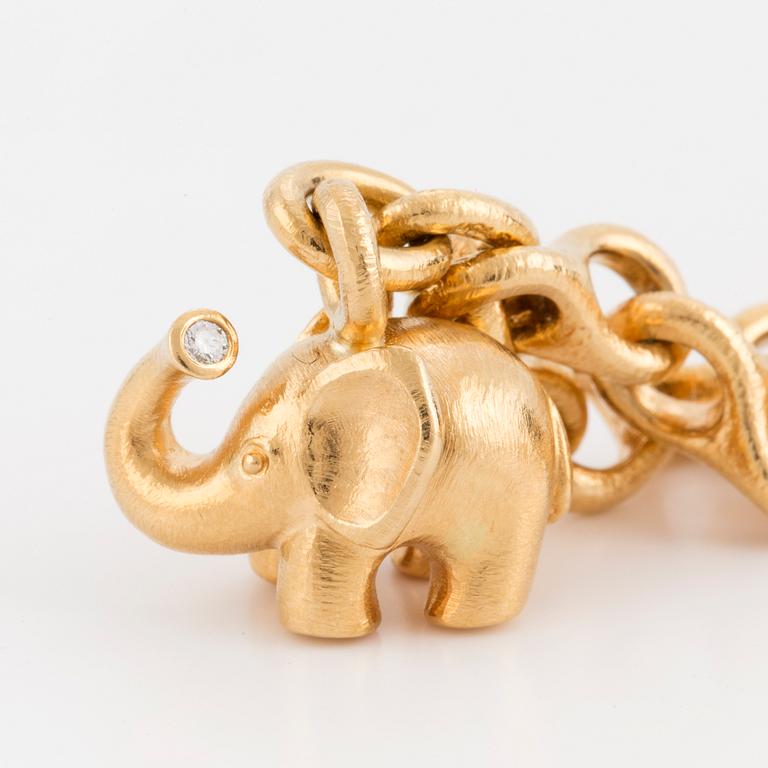 A bracelet by Ole Lynggaard with charms in the shape of elephant and heart.