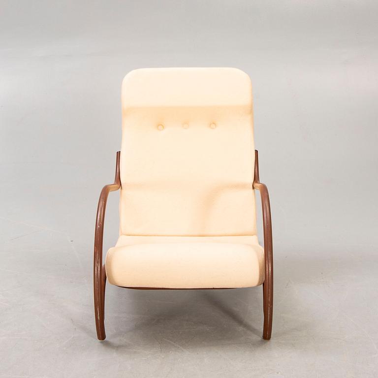 A 1930/40s metal and textile/plastic easy chair.