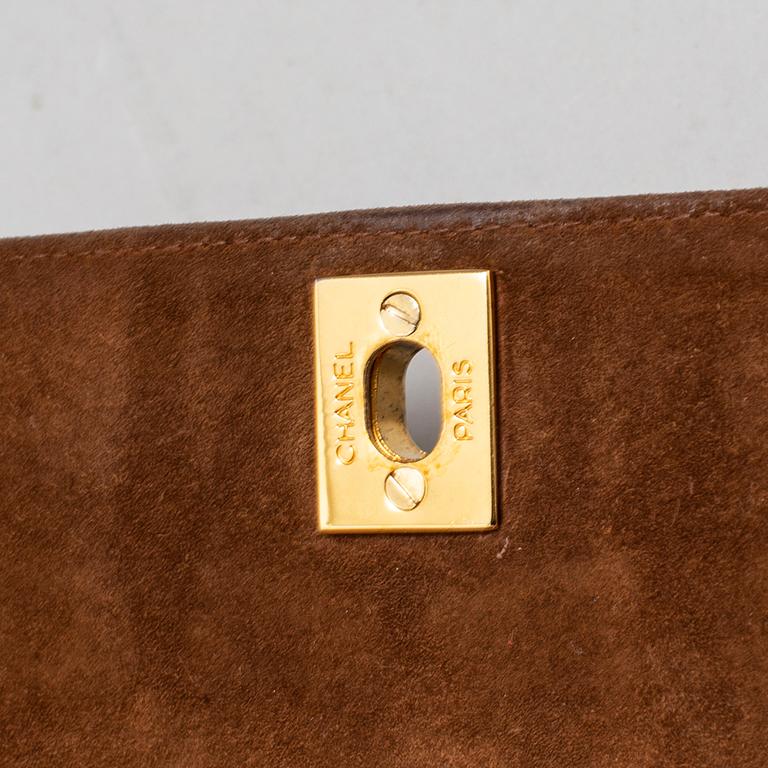 CHANEL, a suede hand bag.