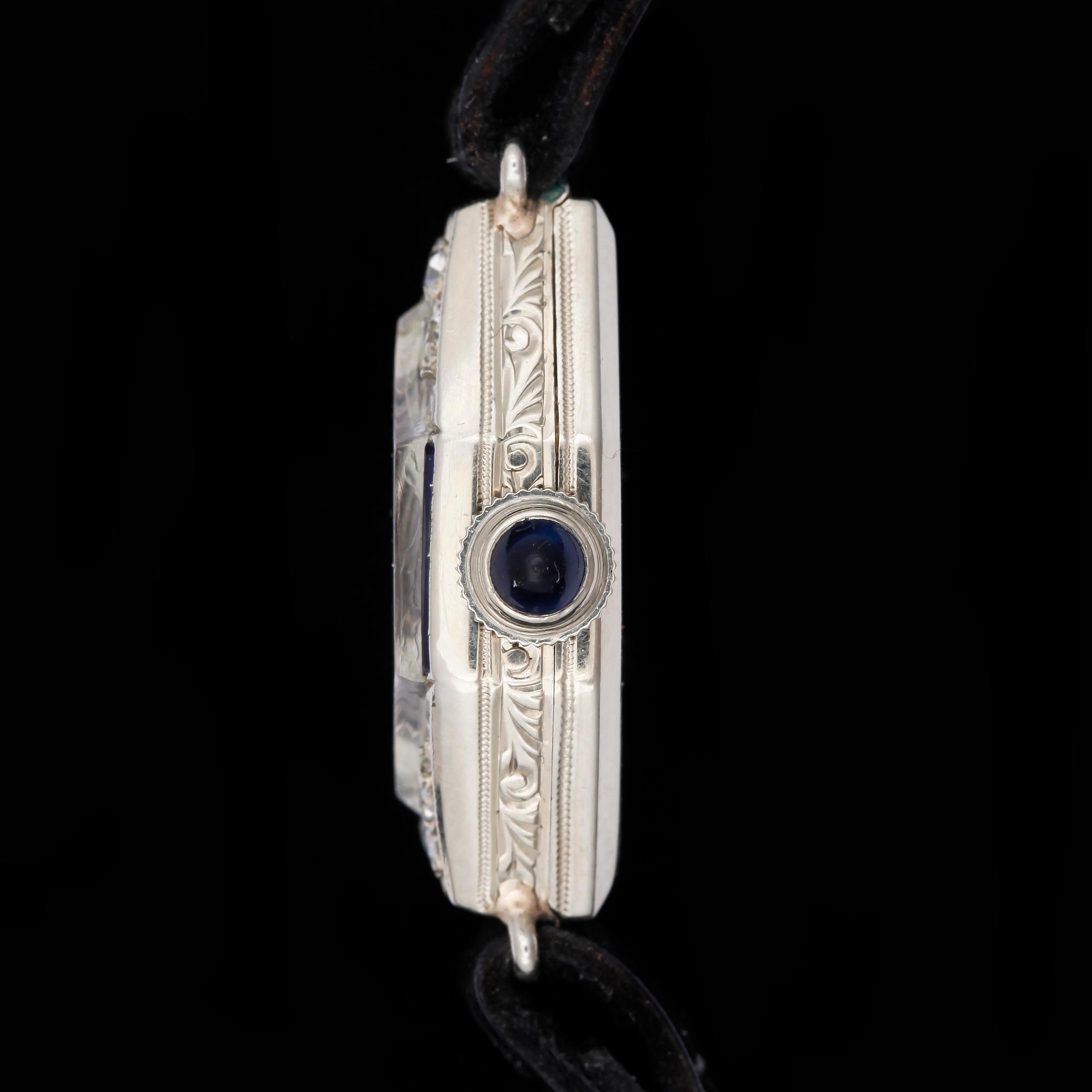 ARMBANDSUR, dam, art deco, 18k vitguld och diamanter tot ca0,20ct och safirer, 1900-talets första hälft.